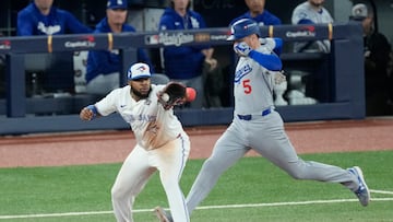 Nov 1, 2025; Toronto, Ontario, CAN; Los Angeles Dodgers first baseman Freddie Freeman (5) is out against Toronto Blue Jays first baseman Vladimir Guerrero Jr. (27) on a double play in the seventh inning during game seven of the 2025 MLB World Series at Rogers Centre. Mandatory Credit: Kevin Sousa-Imagn Images